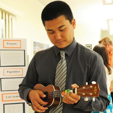 Occupational Therapy major Ryan Hua demonstrates the Weighted Finger Buddy by playing a ukulele at the Touro University Nevada campus in Henderson, Wednesday, May 28, 2014. The devices will help a person with strength issues to use their fingers with better control. (Jerry Henkel/Las Vegas Review-Journal)