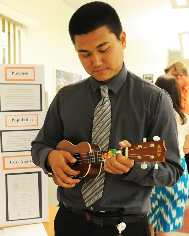 Occupational Therapy major Ryan Hua demonstrates the Weighted Finger Buddy by playing a ukulele at the Touro University Nevada campus in Henderson, Wednesday, May 28, 2014. The devices will help a person with strength issues to use their fingers with better control. (Jerry Henkel/Las Vegas Review-Journal)